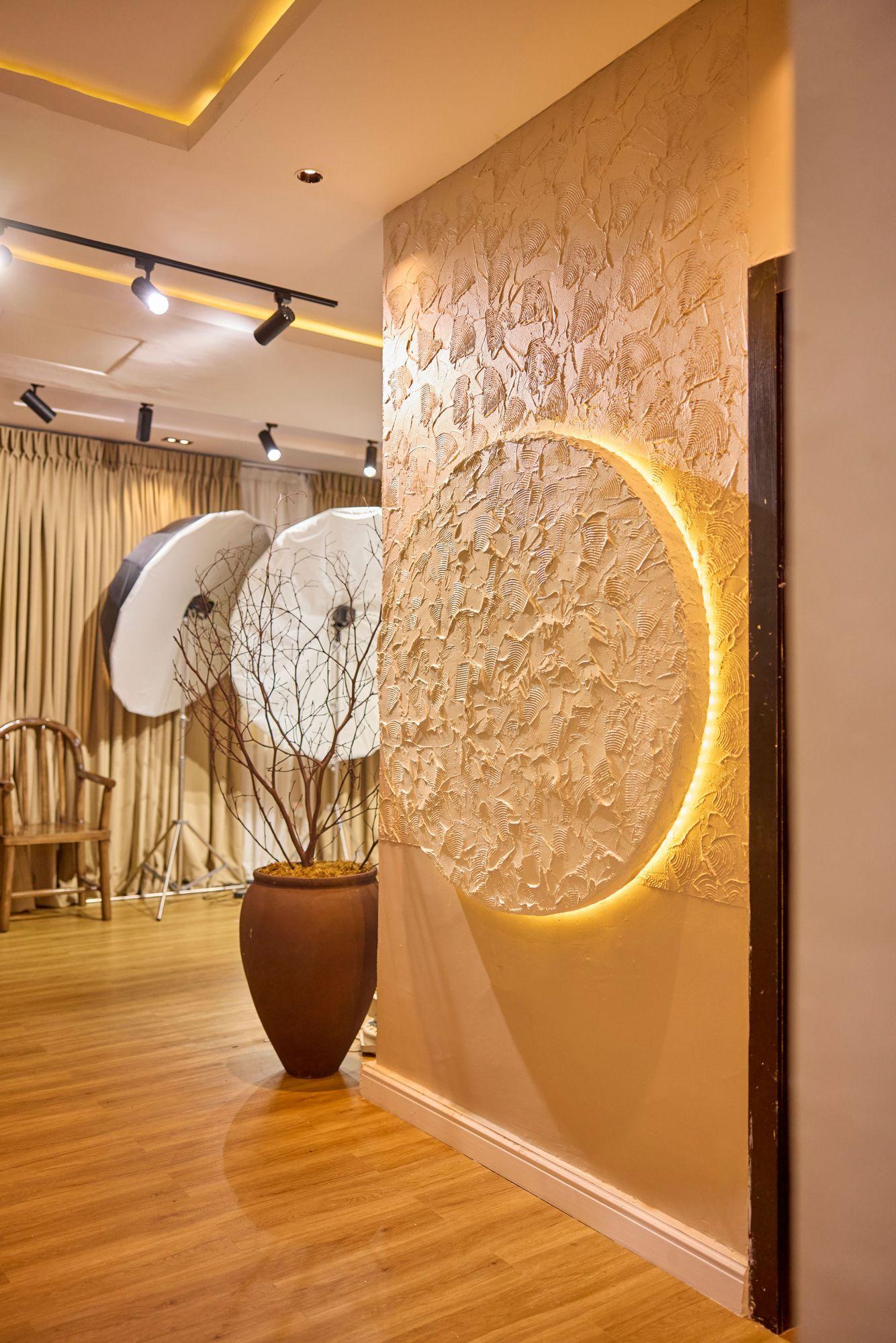 Backlit plaster disc on a hand textured wall