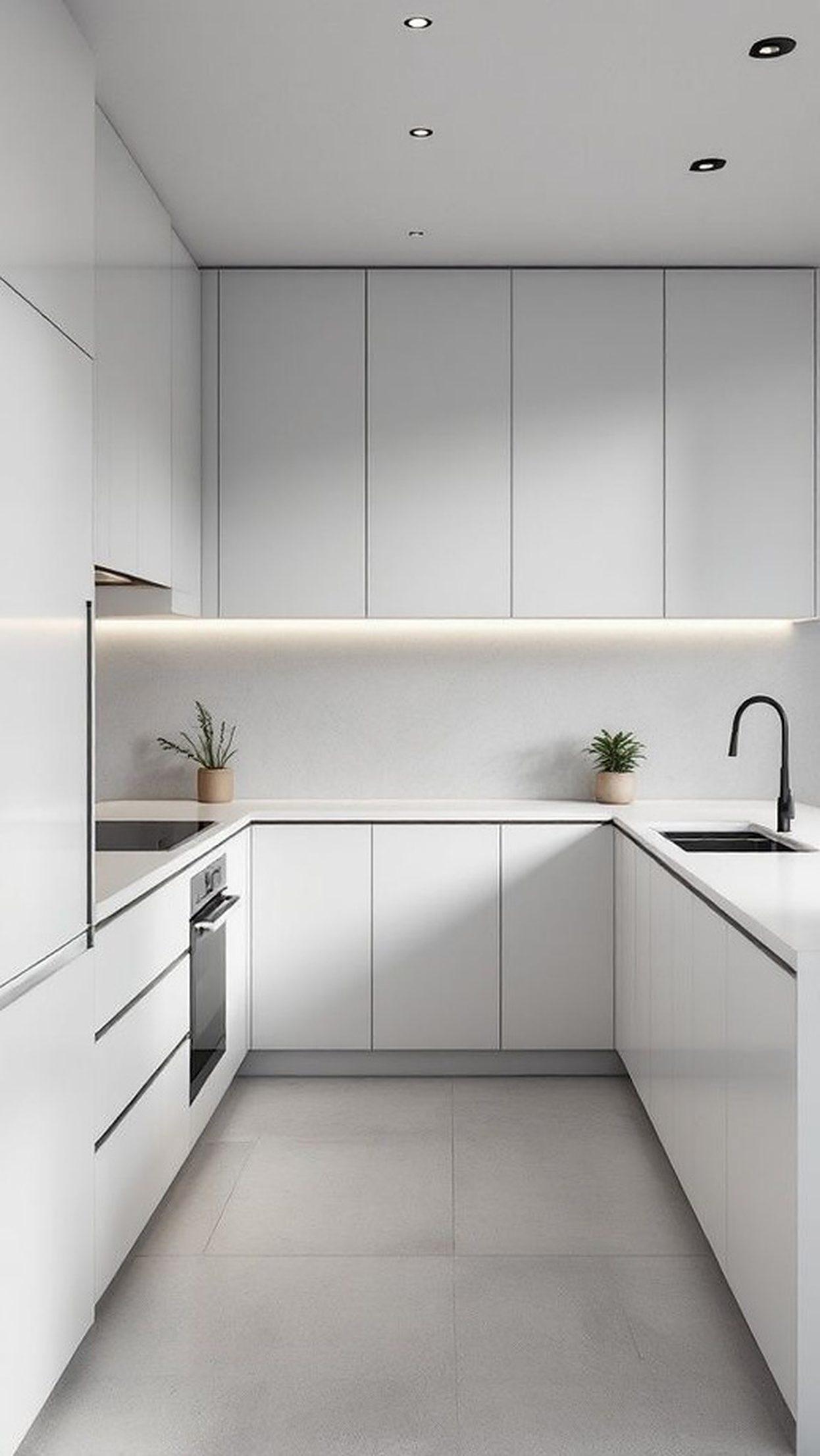 Commercial kitchen line with handleless white cabinetry and under cabinet lighting